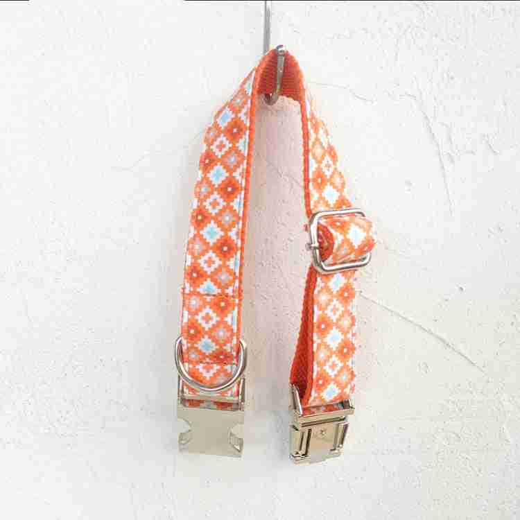 Dog leash set with orange patterned fabric and metal hardware