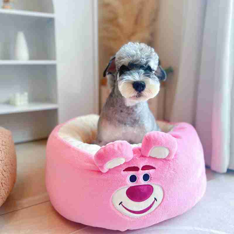 Dog in pink plush animal-shaped pet bed