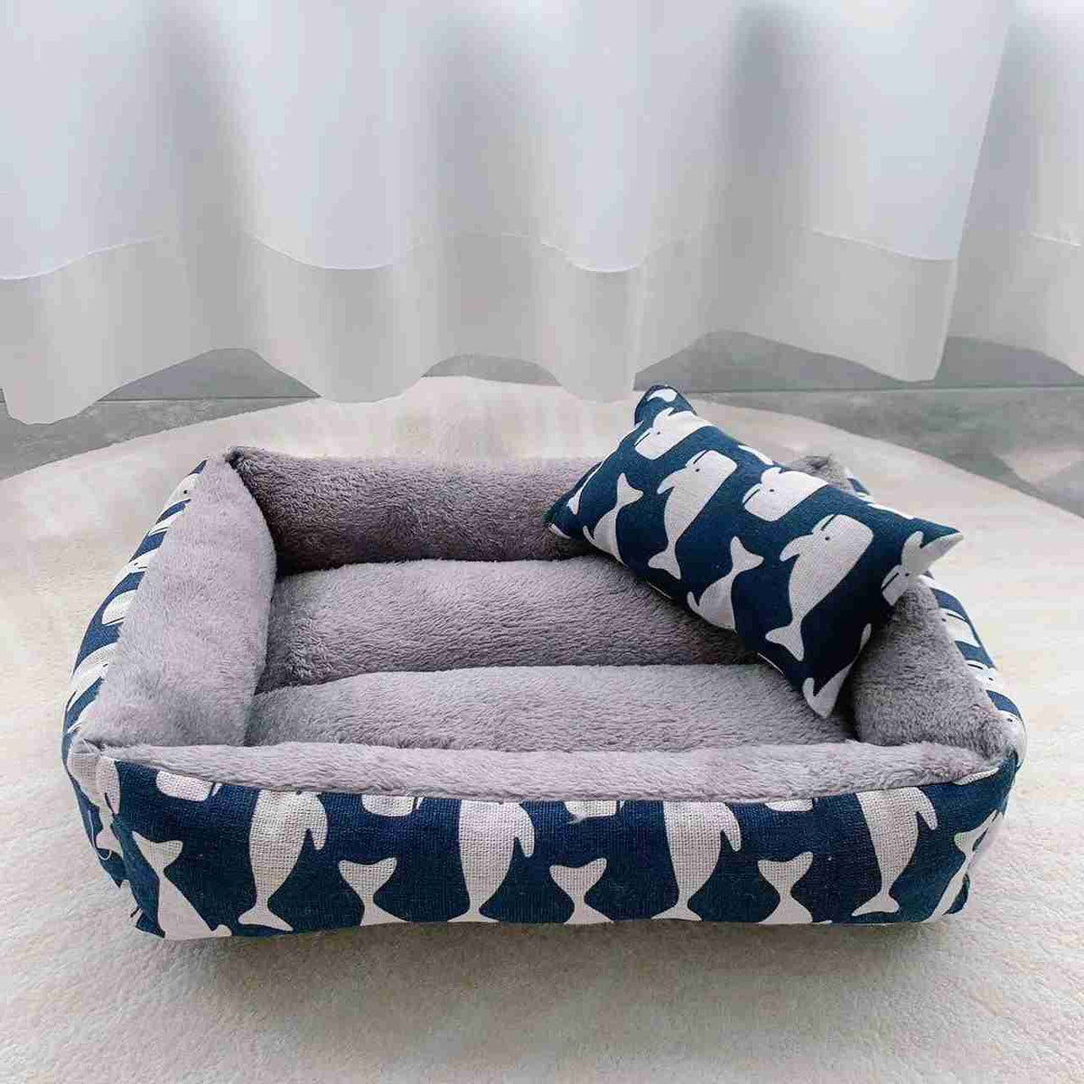 Gray plush pet bed with fish-themed pillow and colorful fabric sides