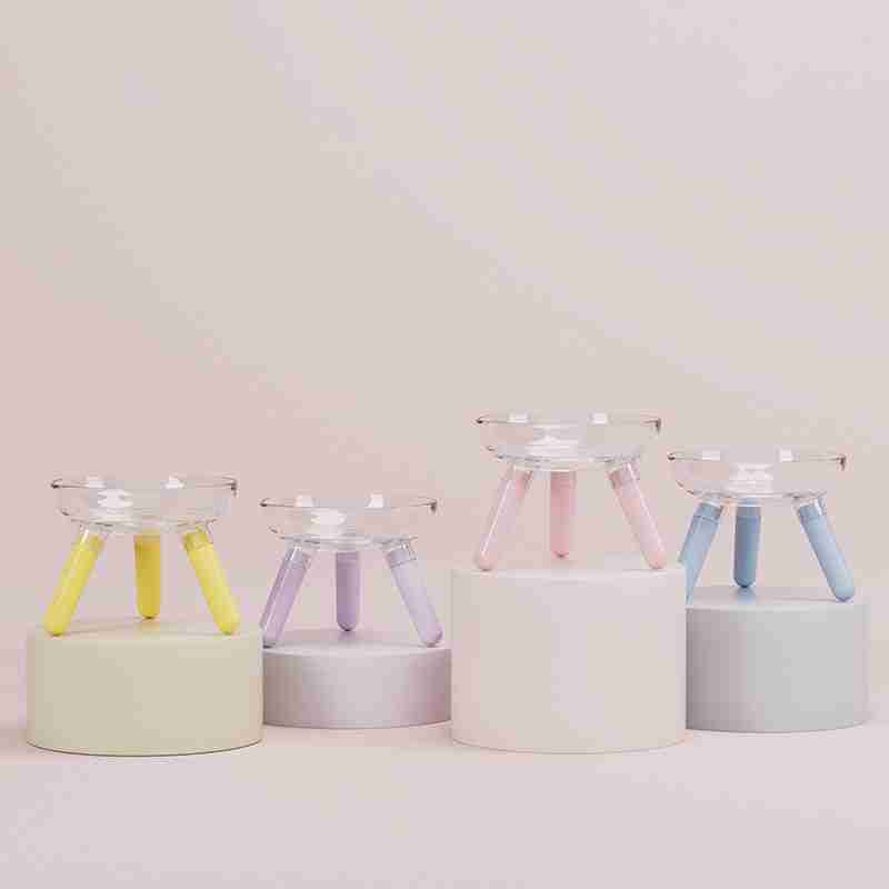 Colorful pet feeding bowls with pastel legs on display