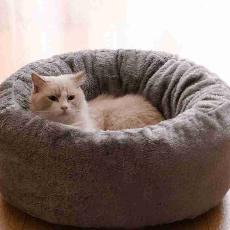 Gray plush pet bed with cat resting inside